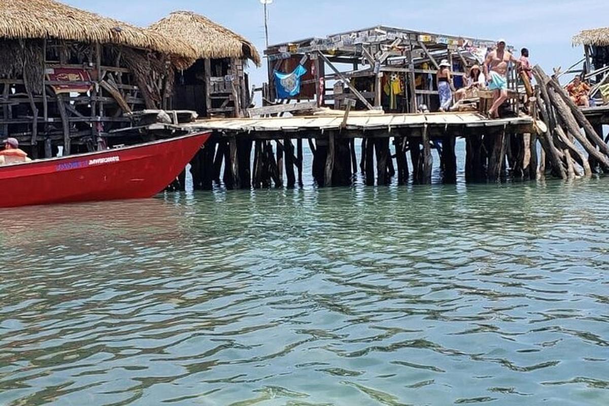 μια κόκκινη βάρκα στο νερό δίπλα σε μια αποβάθρα