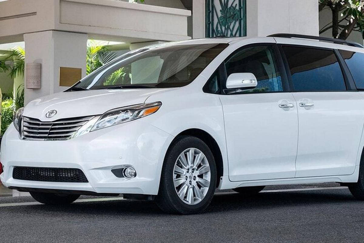 un minivan bianco parcheggiato davanti a un edificio