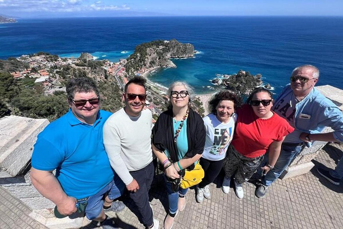 a group of people standing on the edge of a cliff