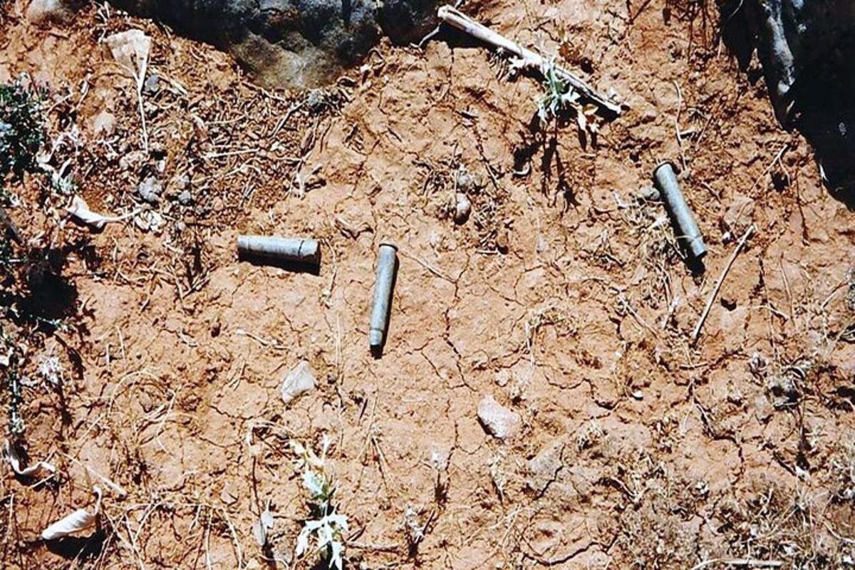 a dirt ground with some bullets on it