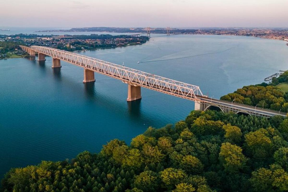 a bridge over a river with trees and water