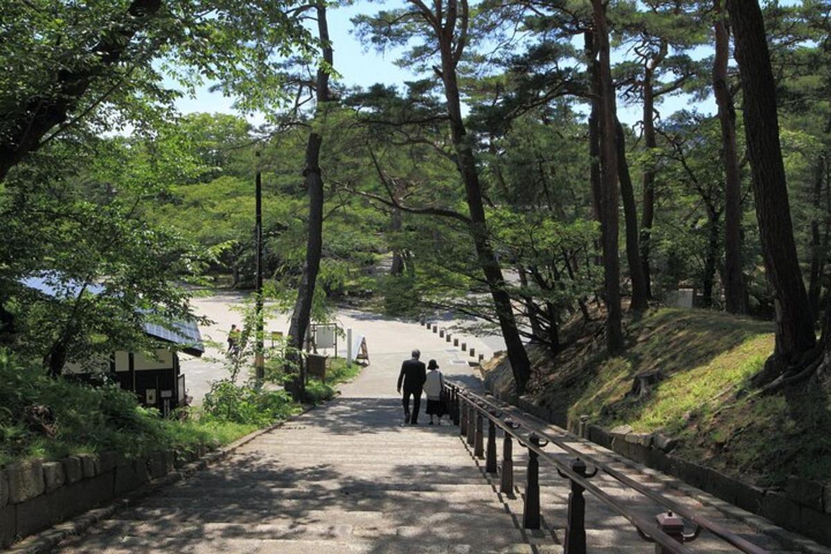 two people walking down a path in a park