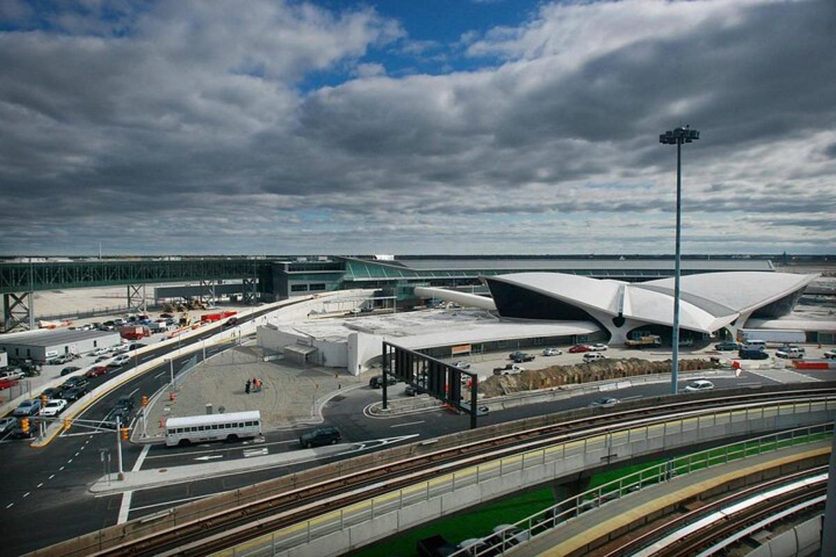 an airport with a large building and a highway