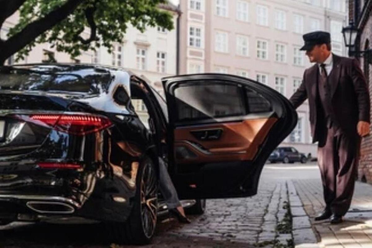 a man standing next to a car with its door open