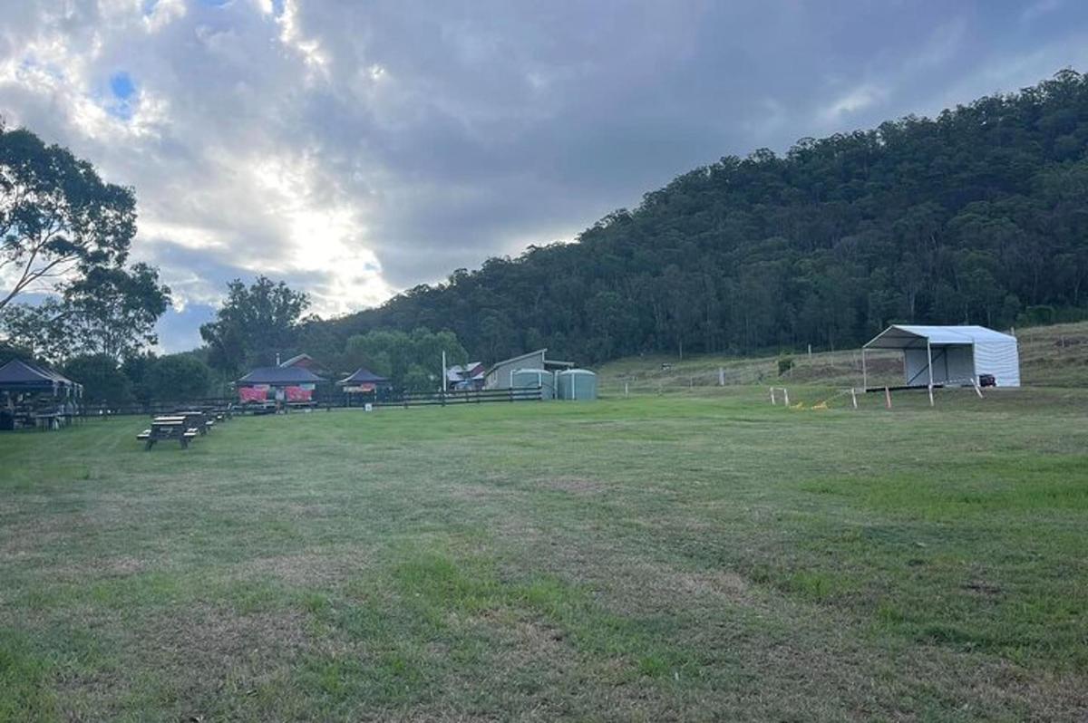 un grande campo con un gruppo di edifici e una tenda