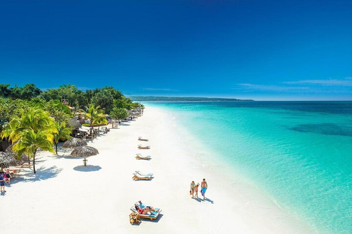 isang beach na may grupo ng mga tao at karagatan