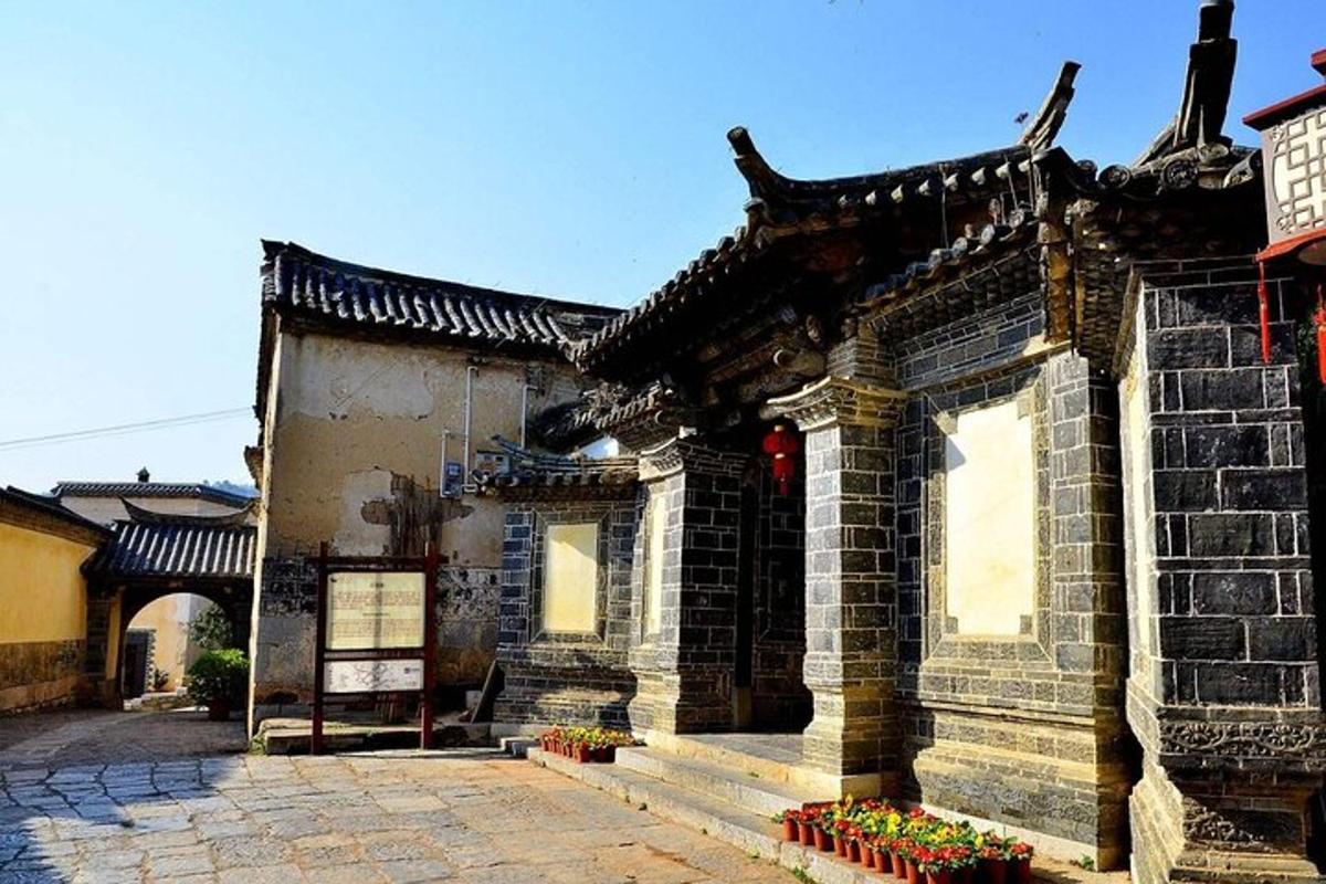 an asian building with flowers in front of it