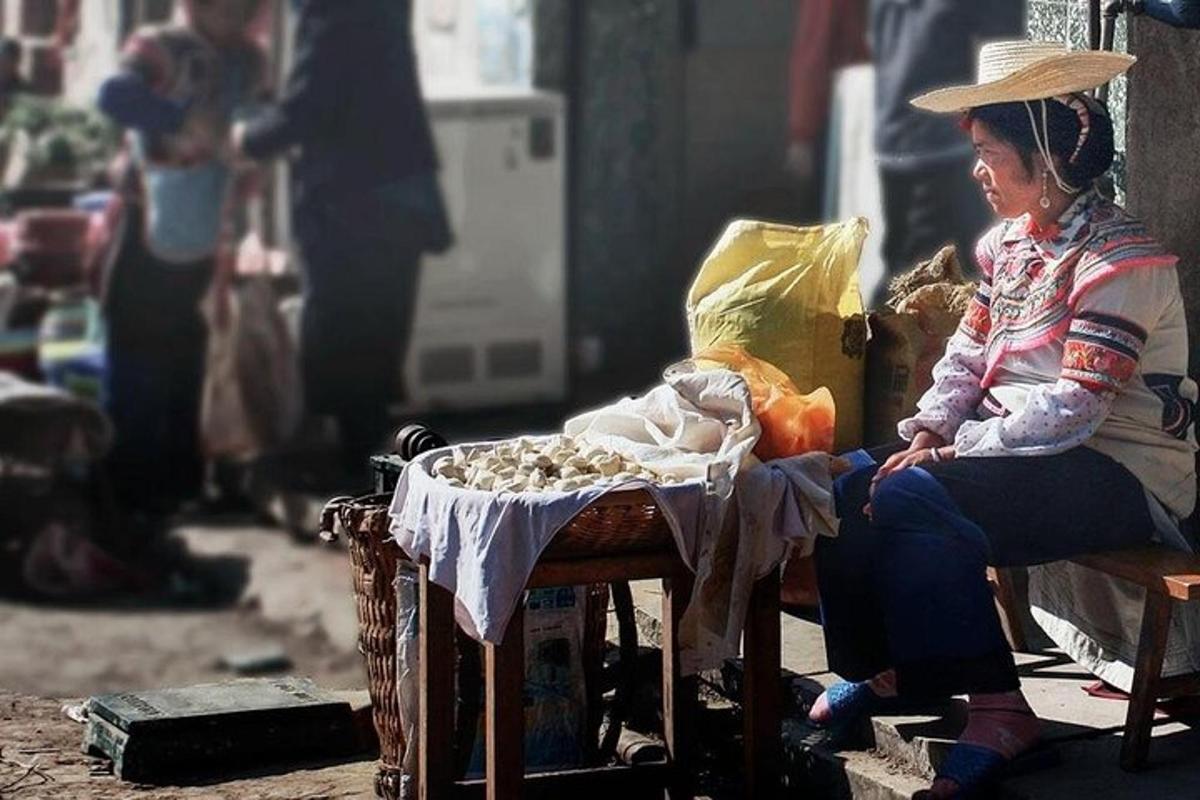 a woman sitting on a bench next to a table