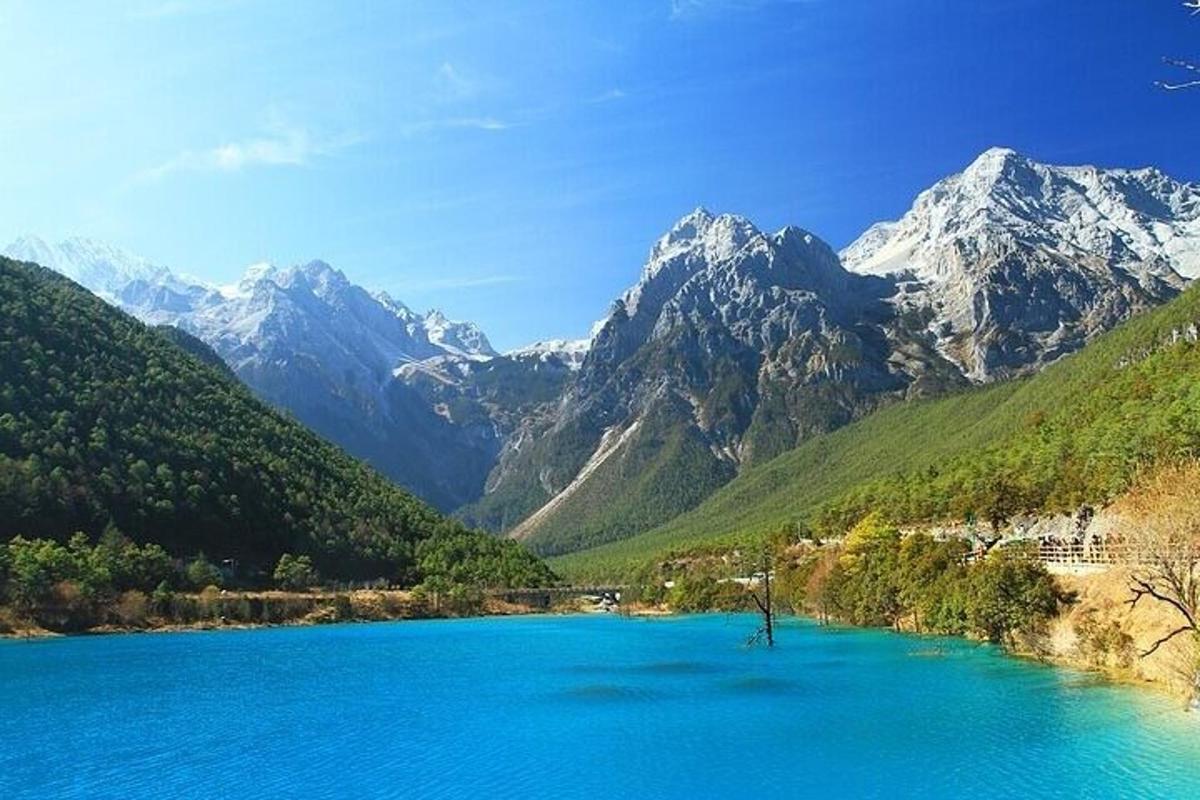 a large blue lake with mountains in the background