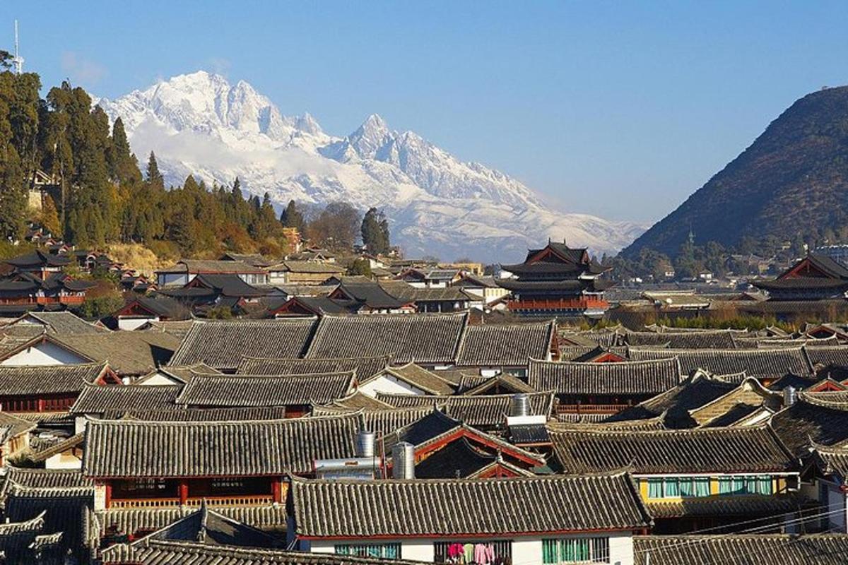 a group of buildings with a mountain in the background