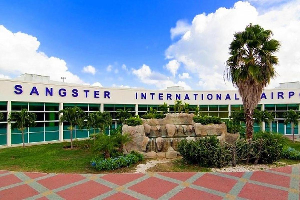 a sanger international airport with a palm tree in front of a building