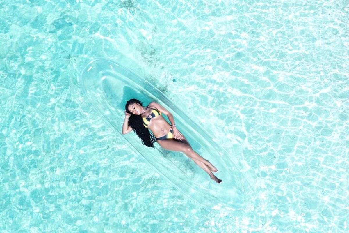 a woman laying on a surfboard in the water