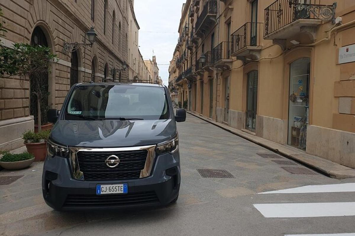 a black suv parked on a street in a city