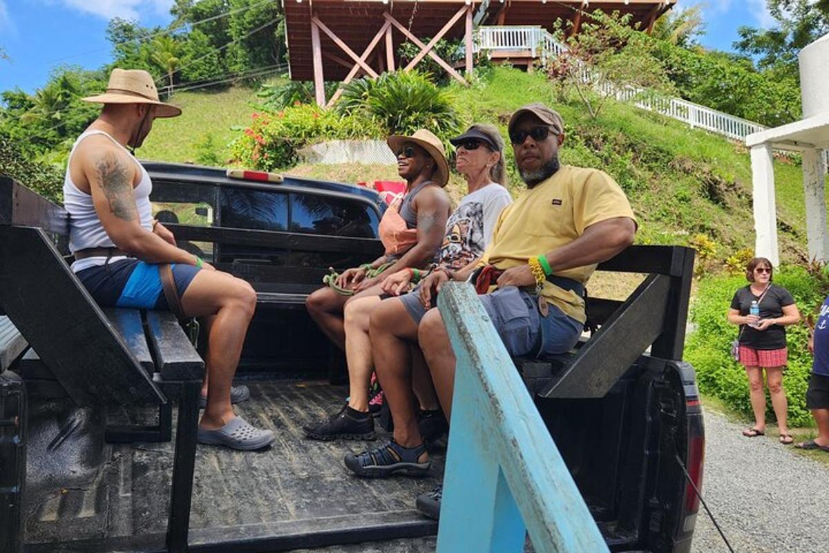 a group of people sitting on the back of a truck