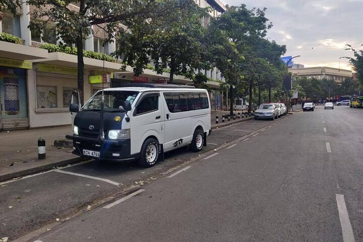 bílá dodávka zaparkovaná na kraji ulice
