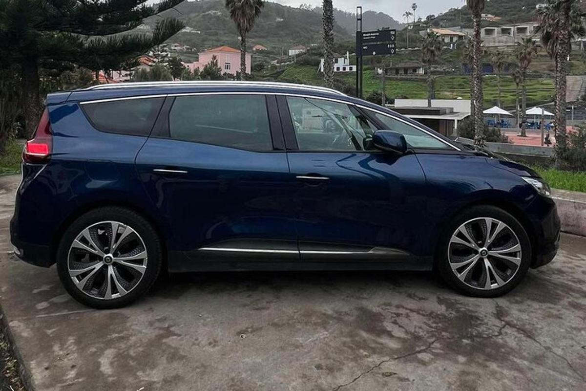 a blue car parked in a parking lot
