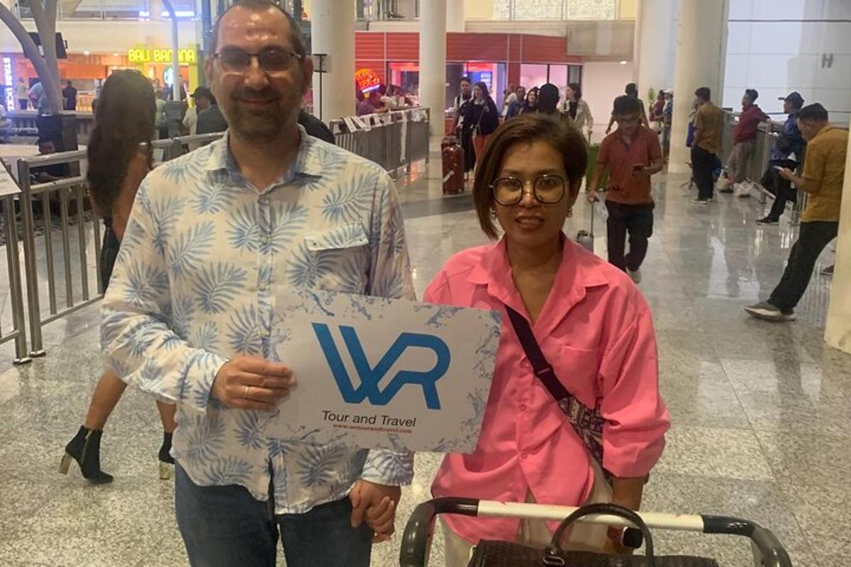 a man and a woman holding a sign with a w sign