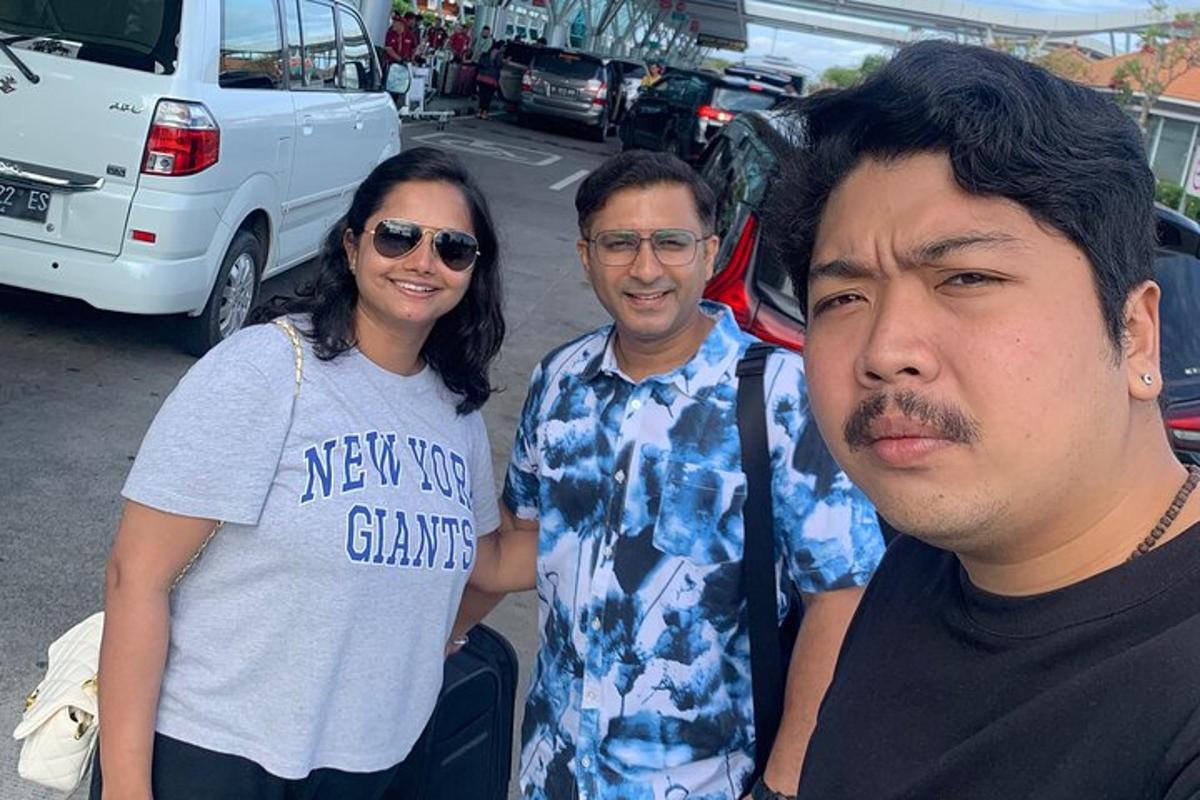 two men and a woman posing for a picture