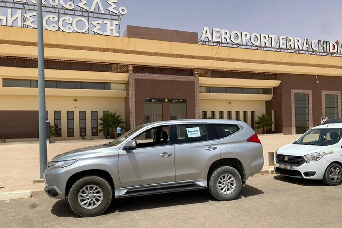 a silver suv parked in front of a building