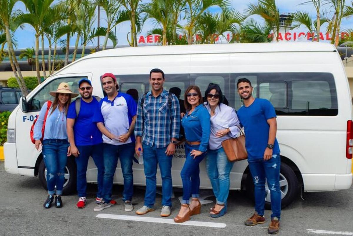 a group of people standing in front of a van