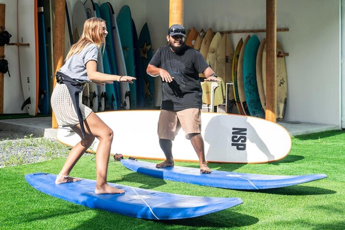 a man and a woman standing on surfboards