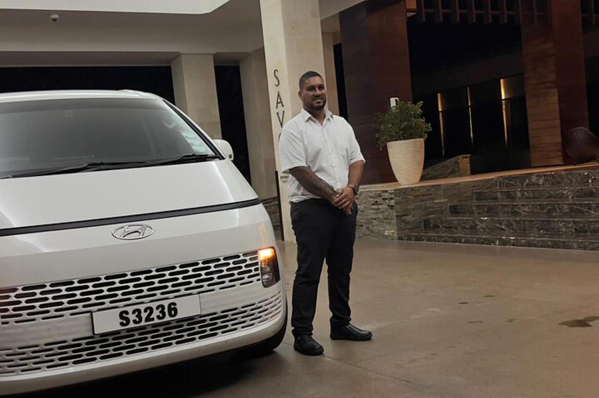 a man standing next to a white truck