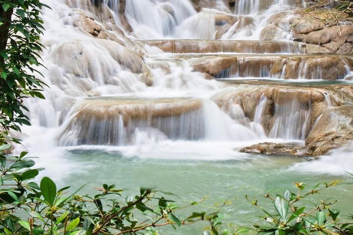 a group of waterfalls in a river with rocks
