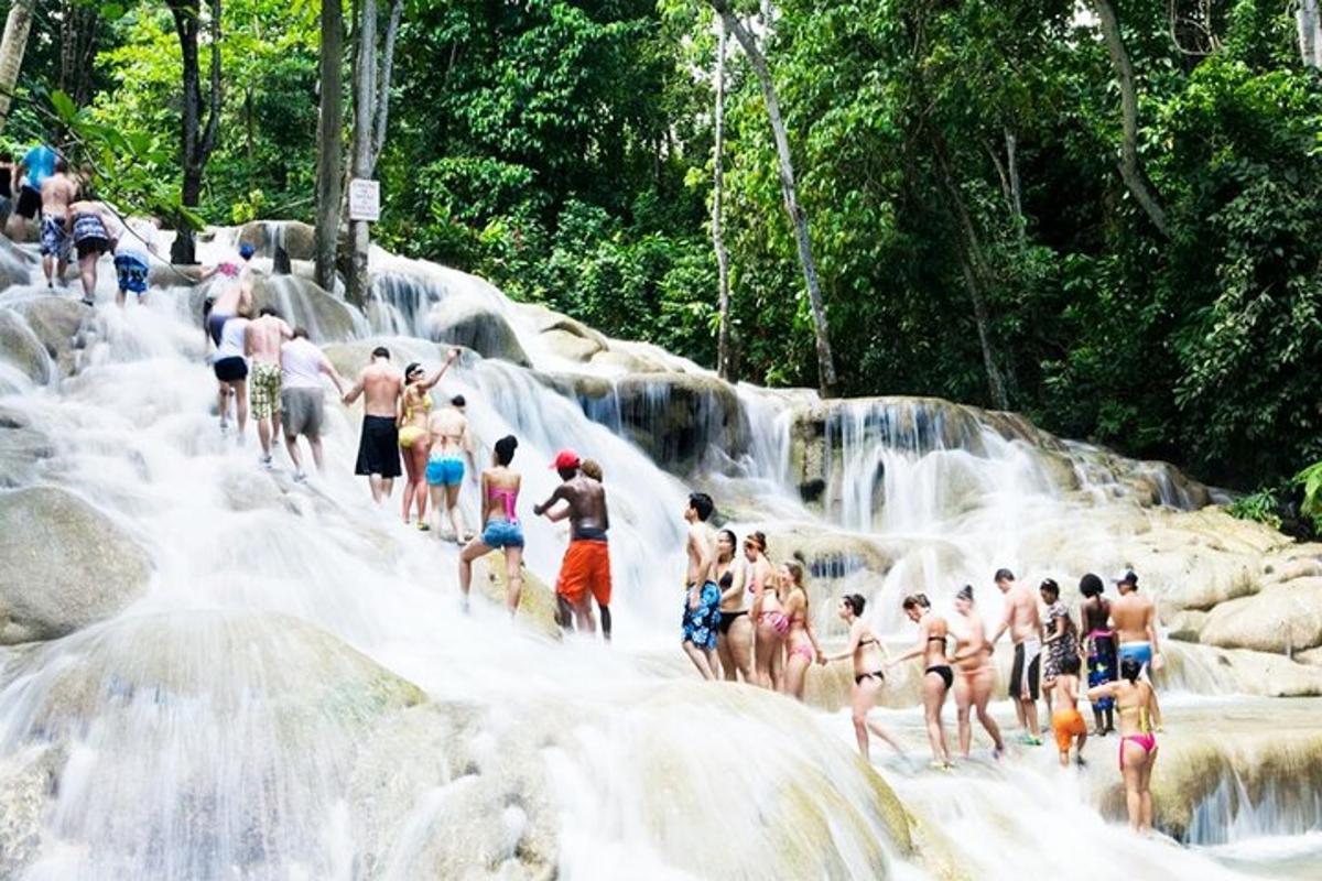 a group of people standing in front of a waterfall