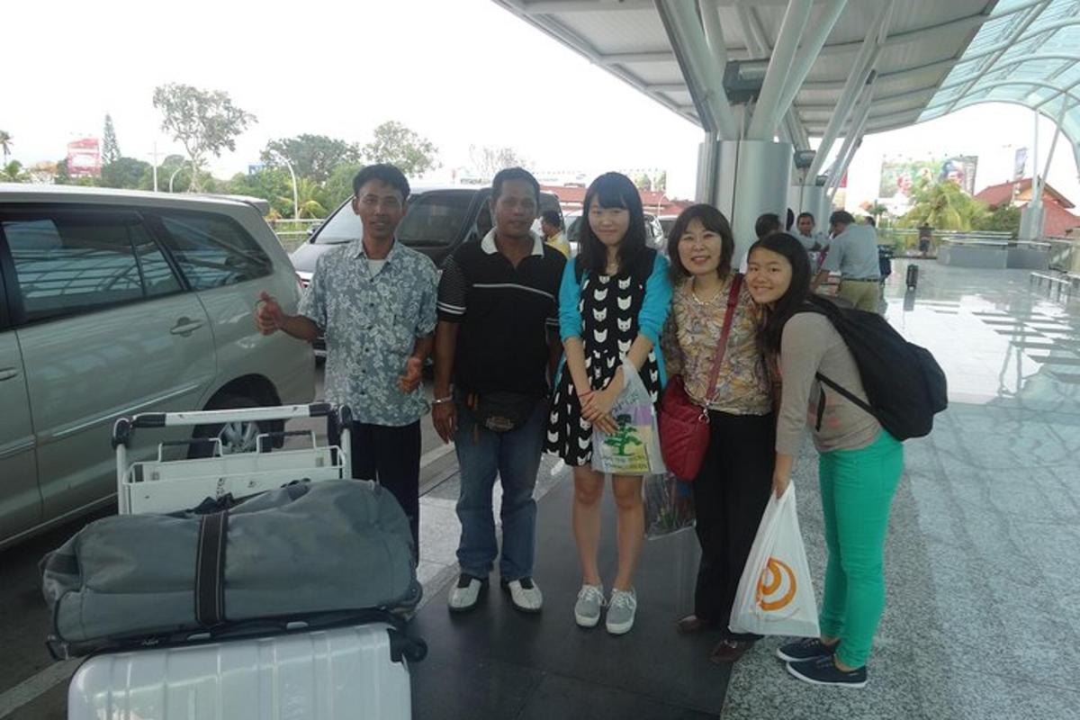 a group of people posing for a picture at an airport