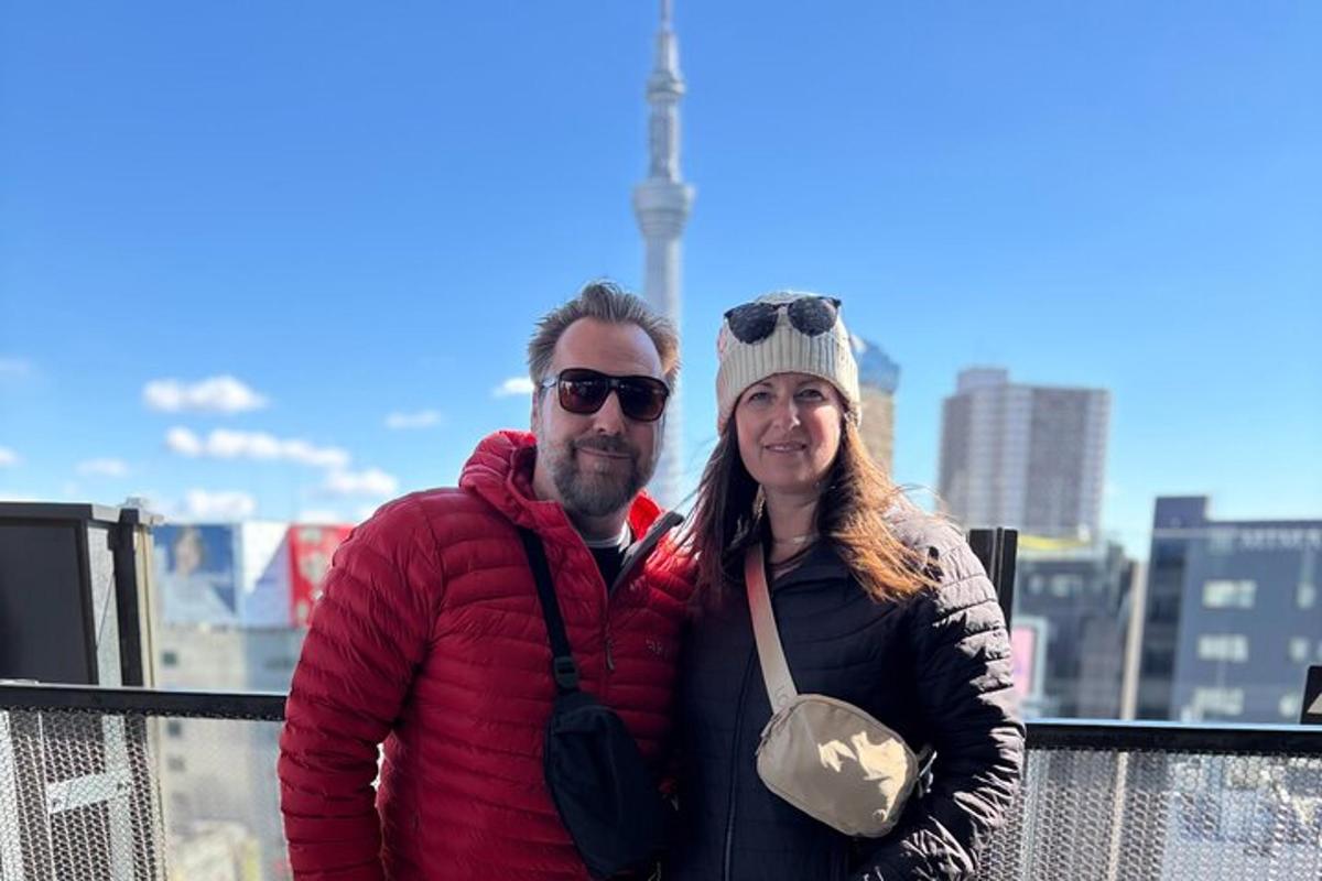 a man and a woman standing on top of a building