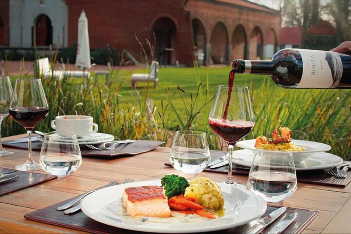 a table with plates of food and a bottle of wine