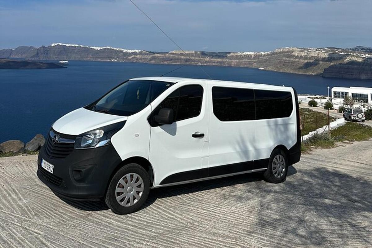 uma van branca estacionada ao lado de um corpo d'água