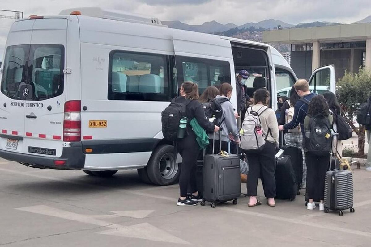 a group of people loading luggage into a white van