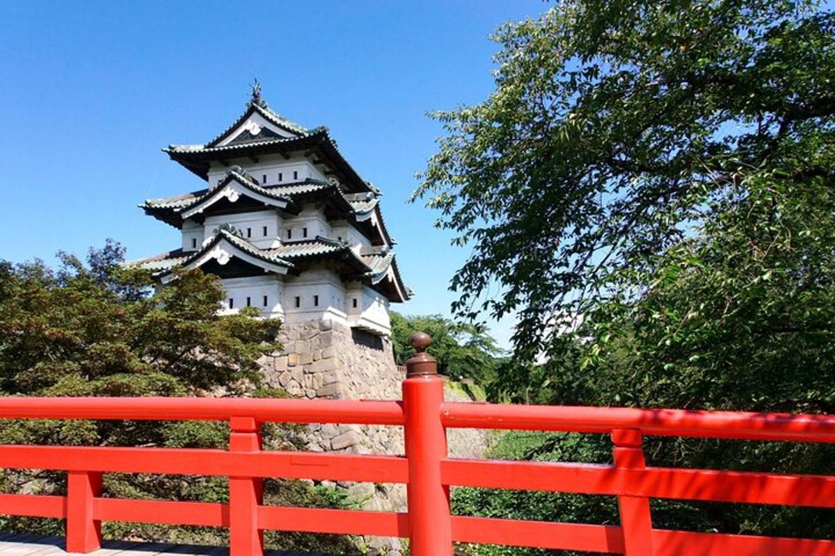 a large castle with a red fence in front of it