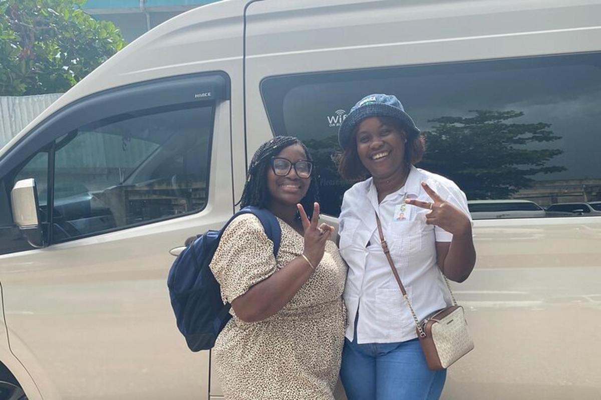 two women are standing in front of a van