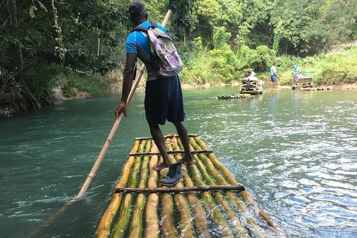 Un hombre con una mochila de pie en una balsa en el agua.