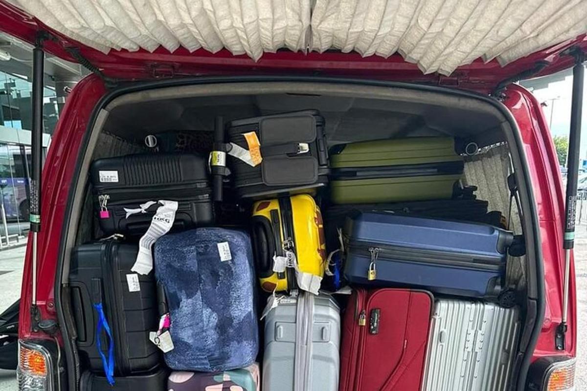 un'auto rossa con il bagagliaio pieno di bagagli