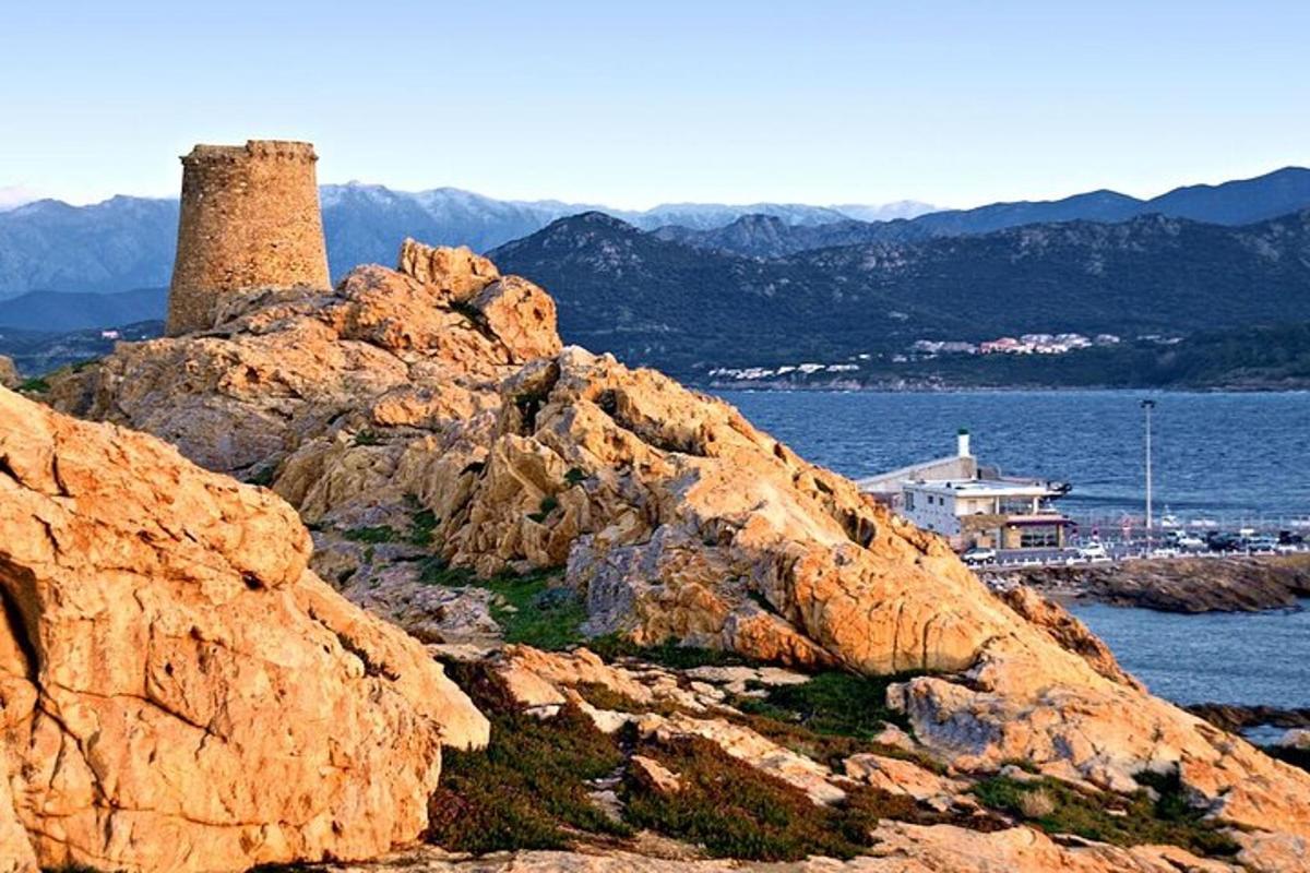 a stone tower sitting on top of a rocky mountain