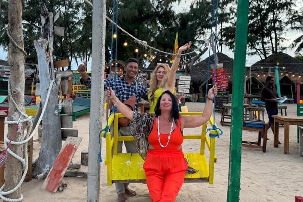 a man and a woman sitting on a swing