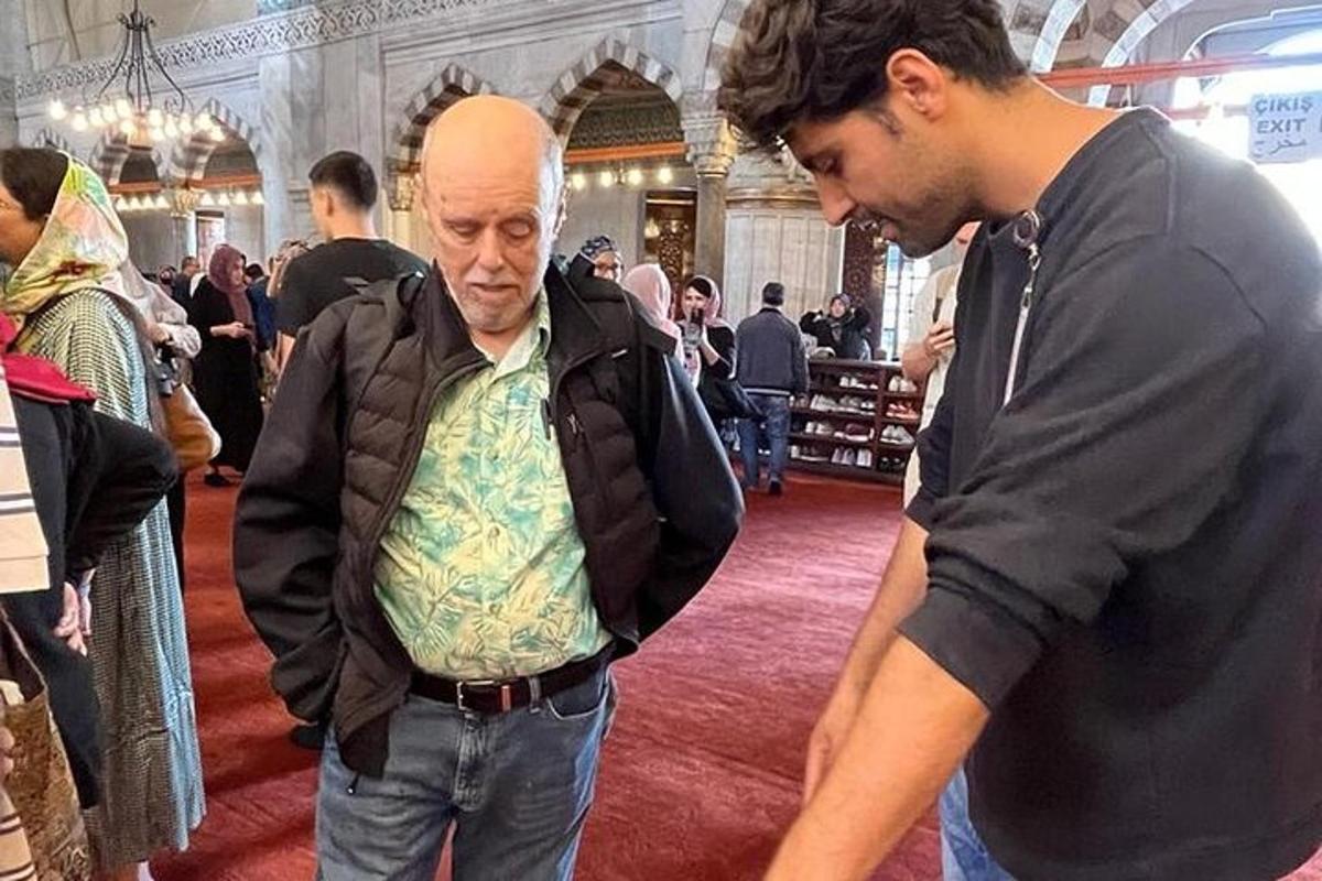 two men standing in a store talking to each other