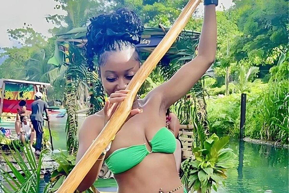 una dona amb un bikini verd que sosté un mirall