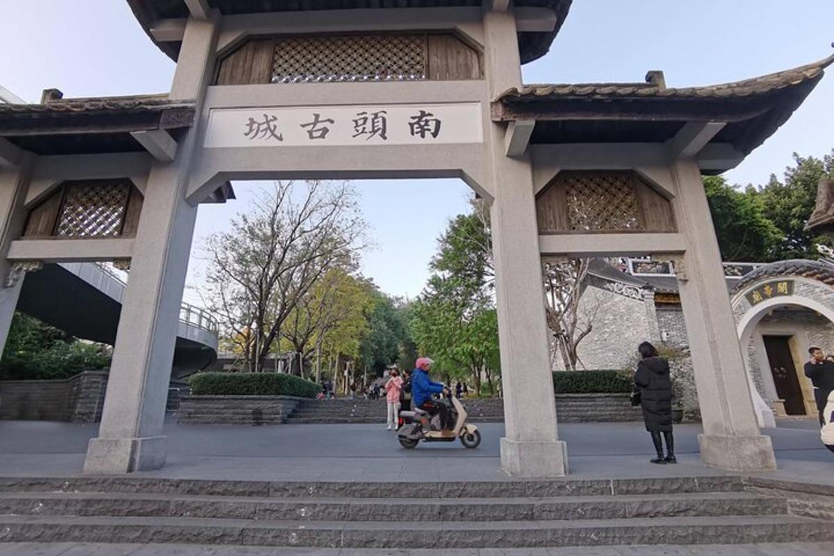 a gate in a park with a person pushing a stroller