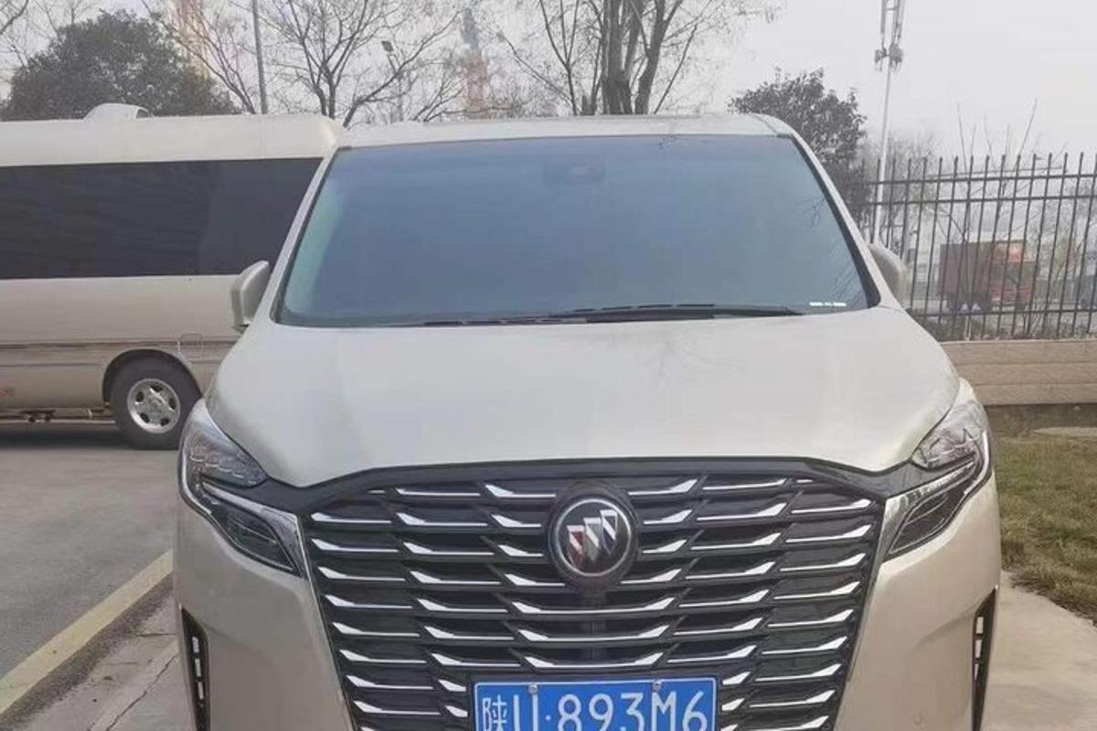 a silver car parked in a parking lot with a van