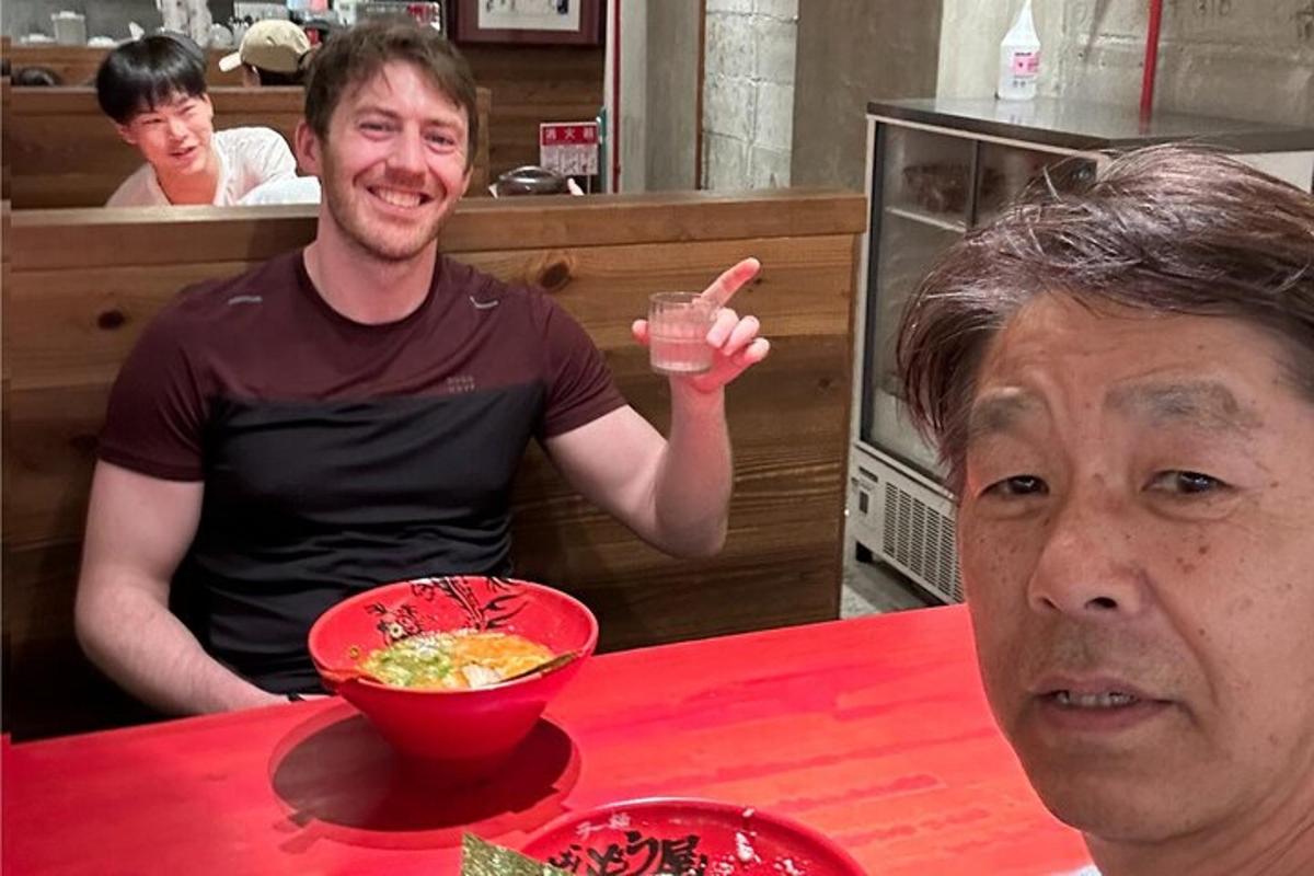 a man sitting at a table with a bowl of food