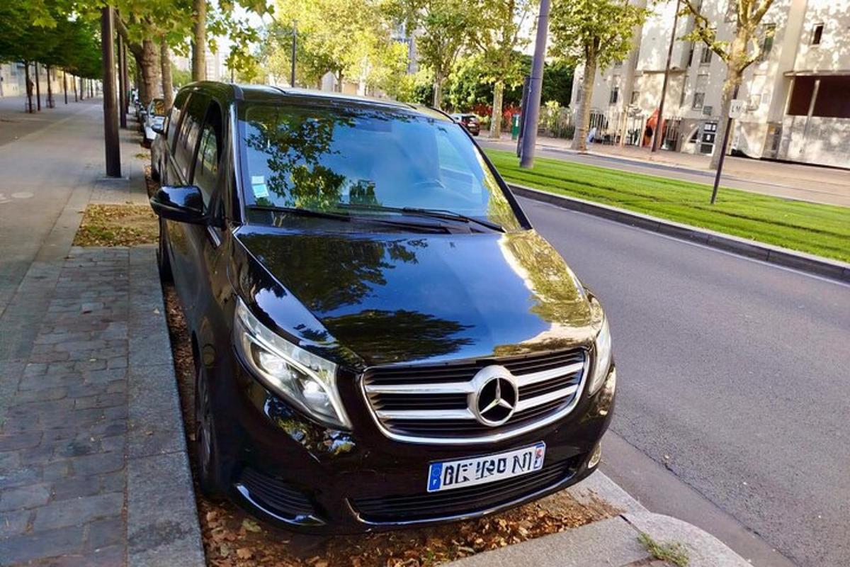 a black car parked on the side of a street