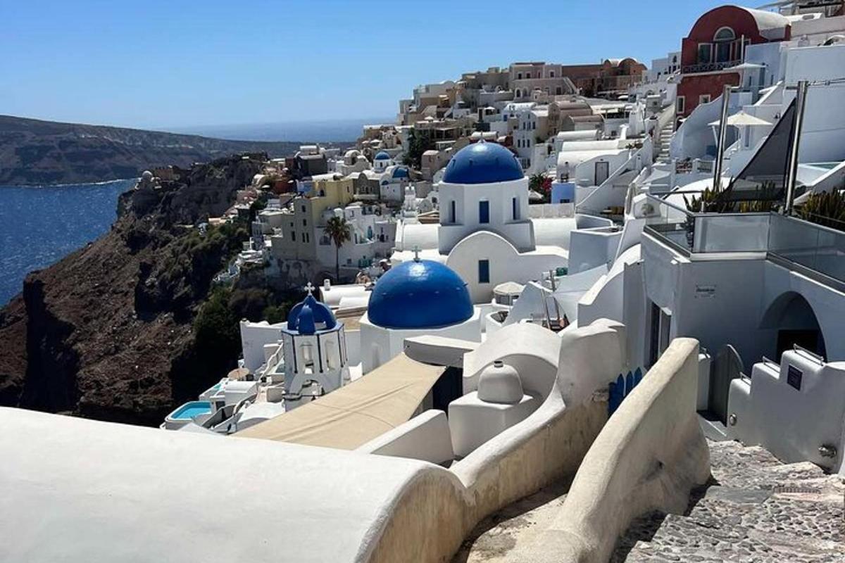 a group of white buildings with blue domes