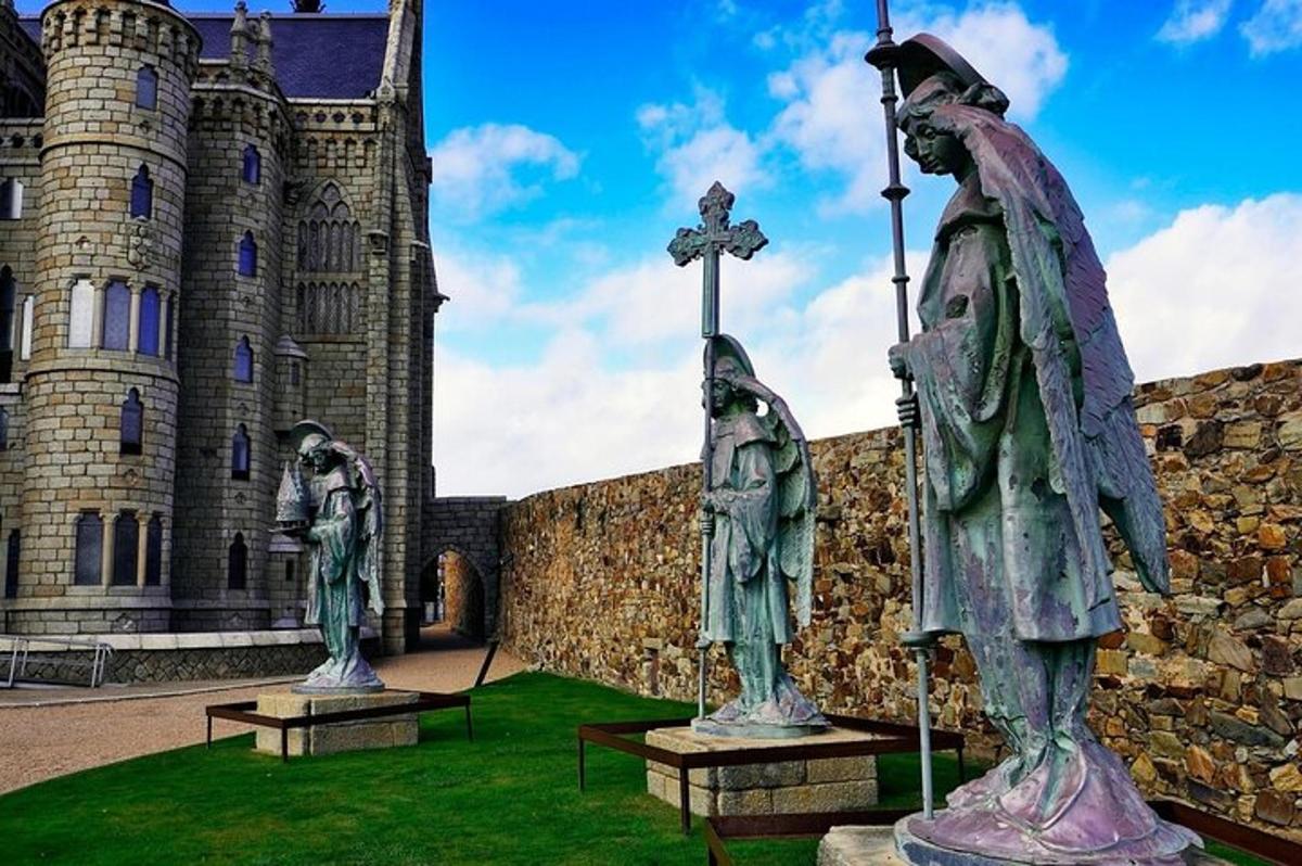 two statues in front of a castle