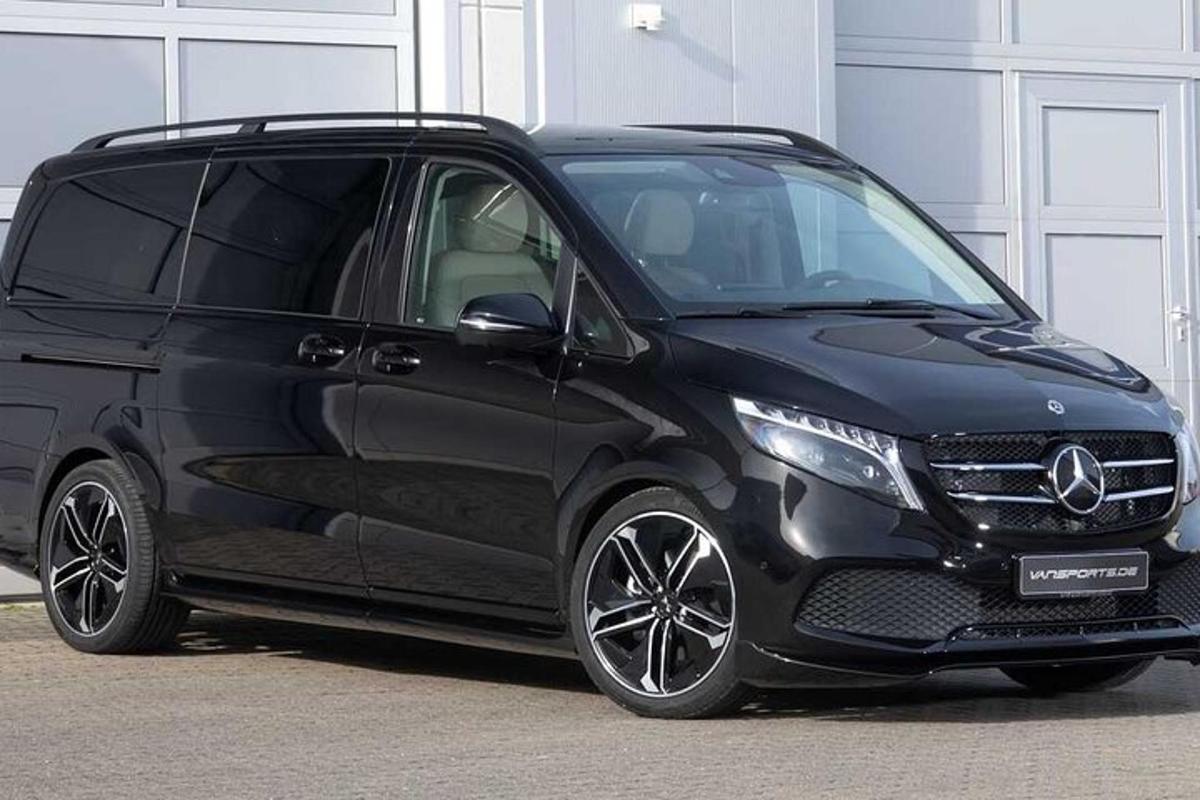 a black mercedes benz minivan parked in a garage