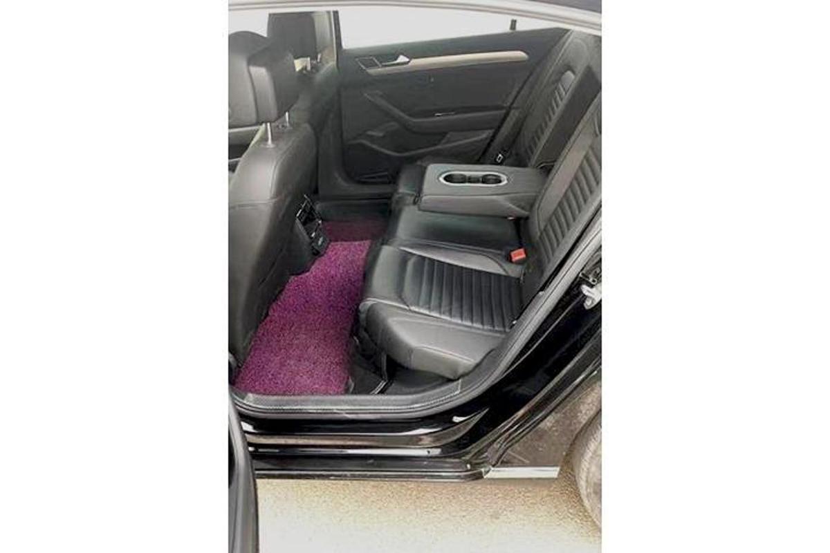 a back seat of a car with a pink carpet