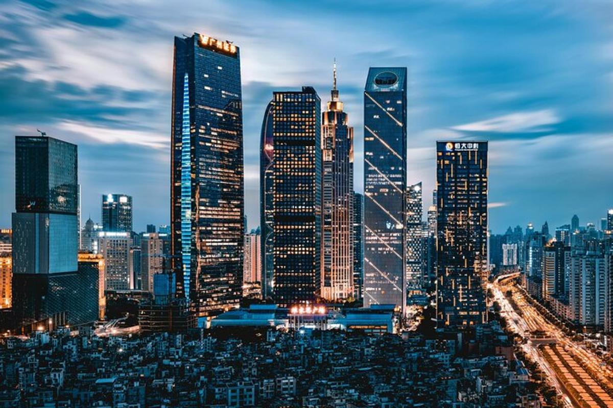 a city skyline at night with tall buildings